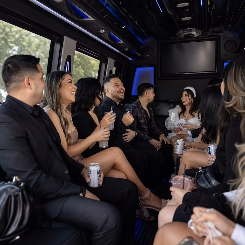 Party bus interior with wraparound leather seating and LED lighting in Lakewood