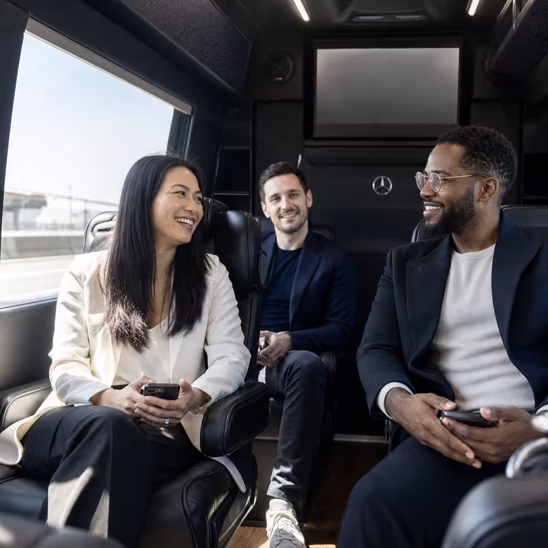 Group boarding a white charter bus for Corporate Transportation transportation in Lakewood
