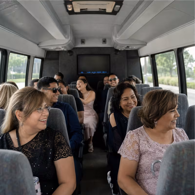 Group boarding a white charter bus for Private Event Transportation transportation in Lakewood