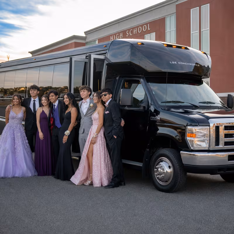 Group boarding a white charter bus for Prom & Homecoming Transportation transportation in Lakewood