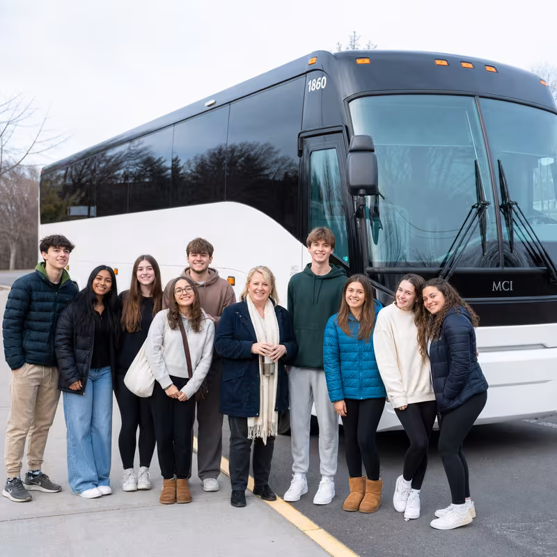 Passengers loading luggage while boarding an Lakewood group shuttle